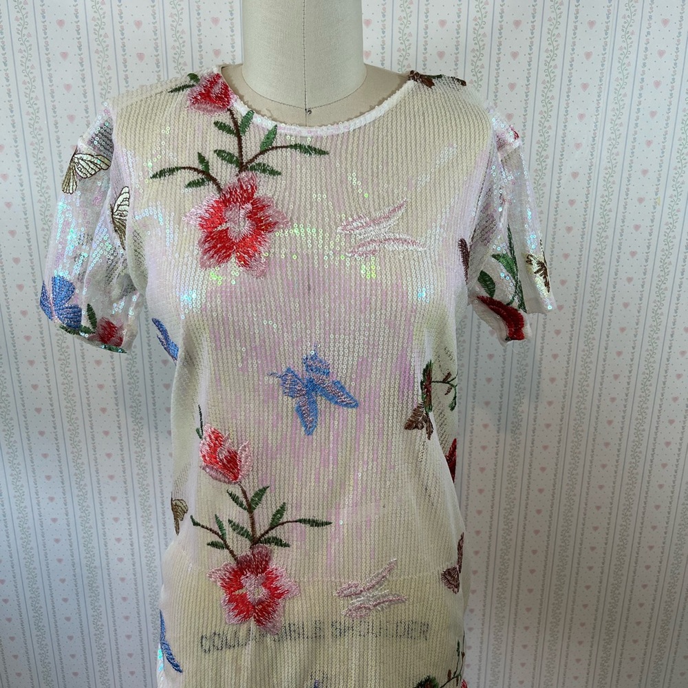 Sheer iridescent opal sequin top with embroidered flowers and butterflies.